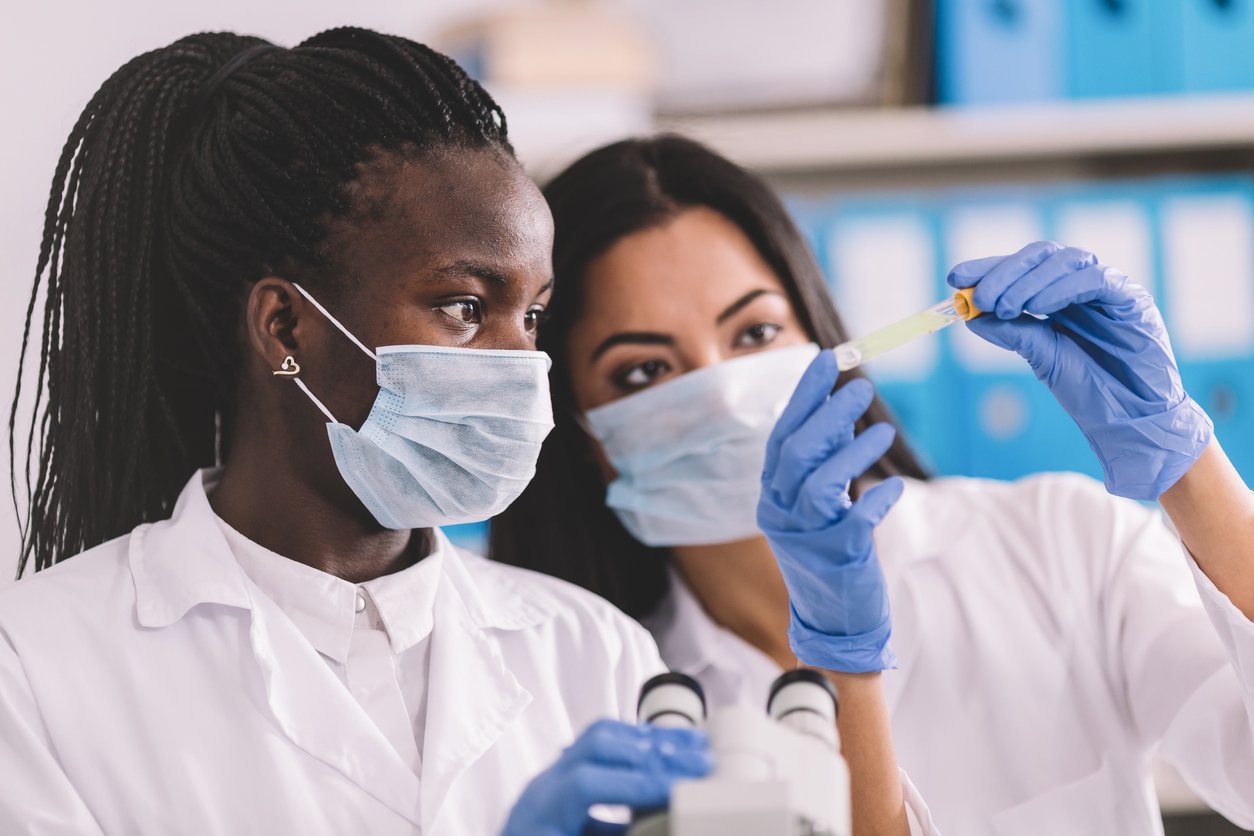 Two doctors looking at a virus for infectious disease research