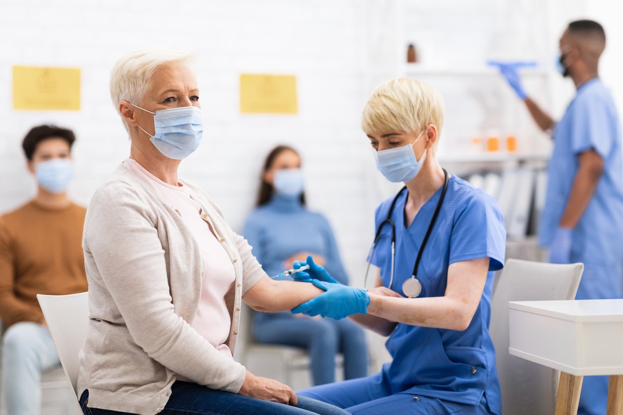 Older woman receiving COVID-19 vaccines