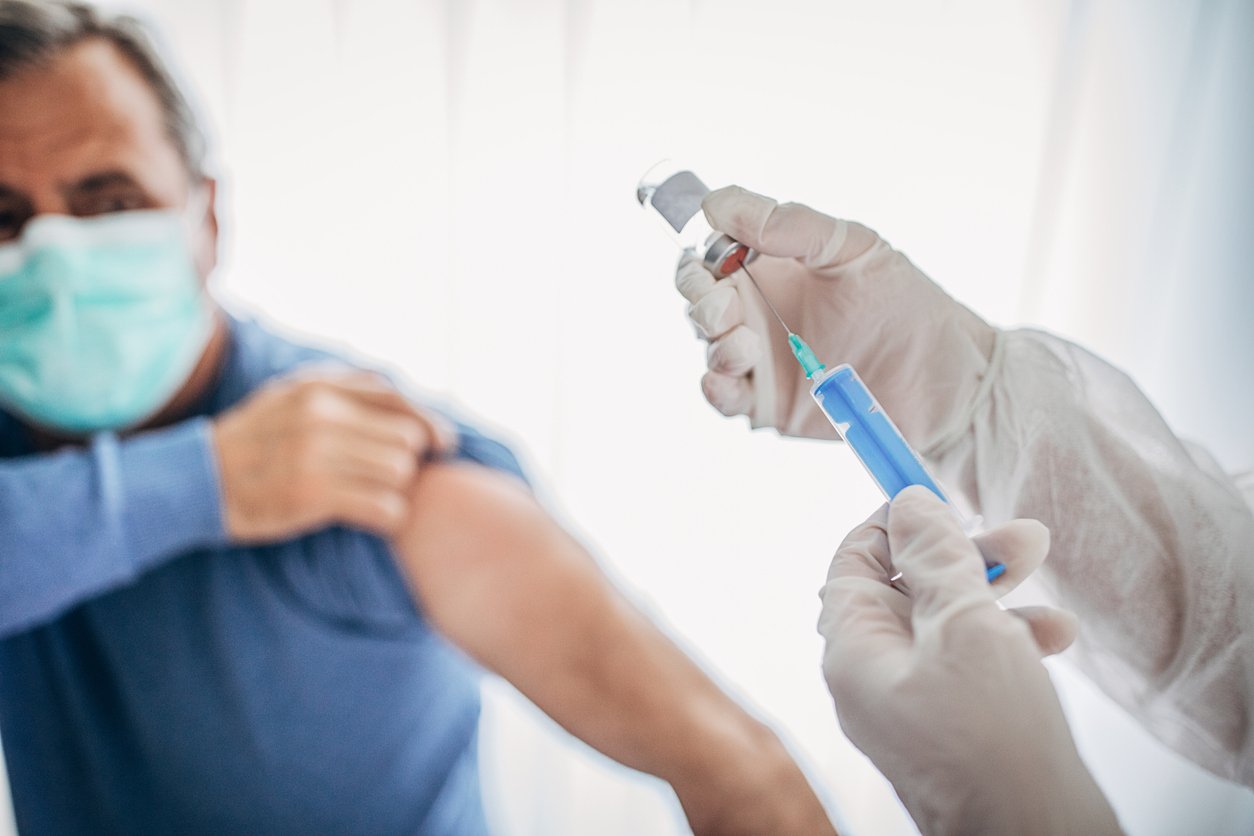 Man receiving a vaccine for viruses